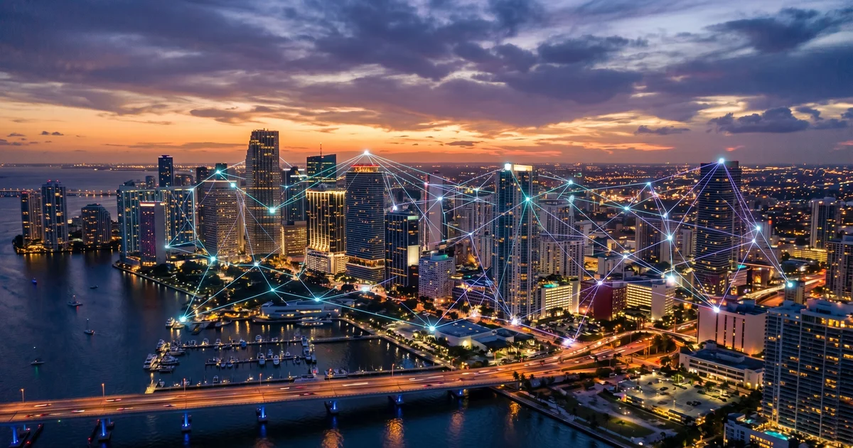Miami skyline at dusk overlaid with a translucent network topology diagram representing managed IT services across South Florida